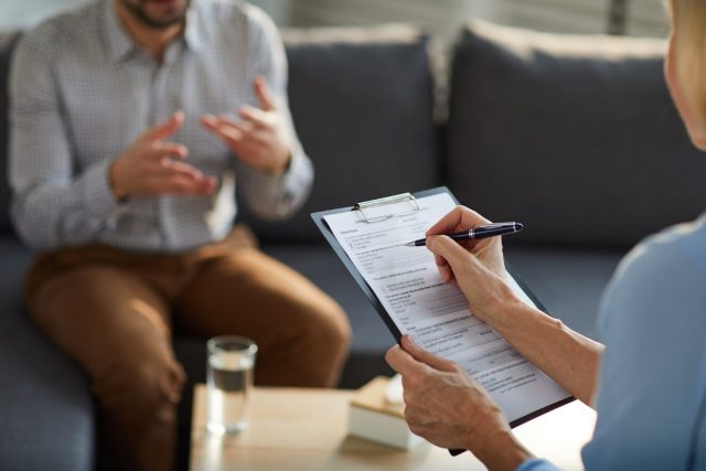 what is family mediation two people discussing with clipboard